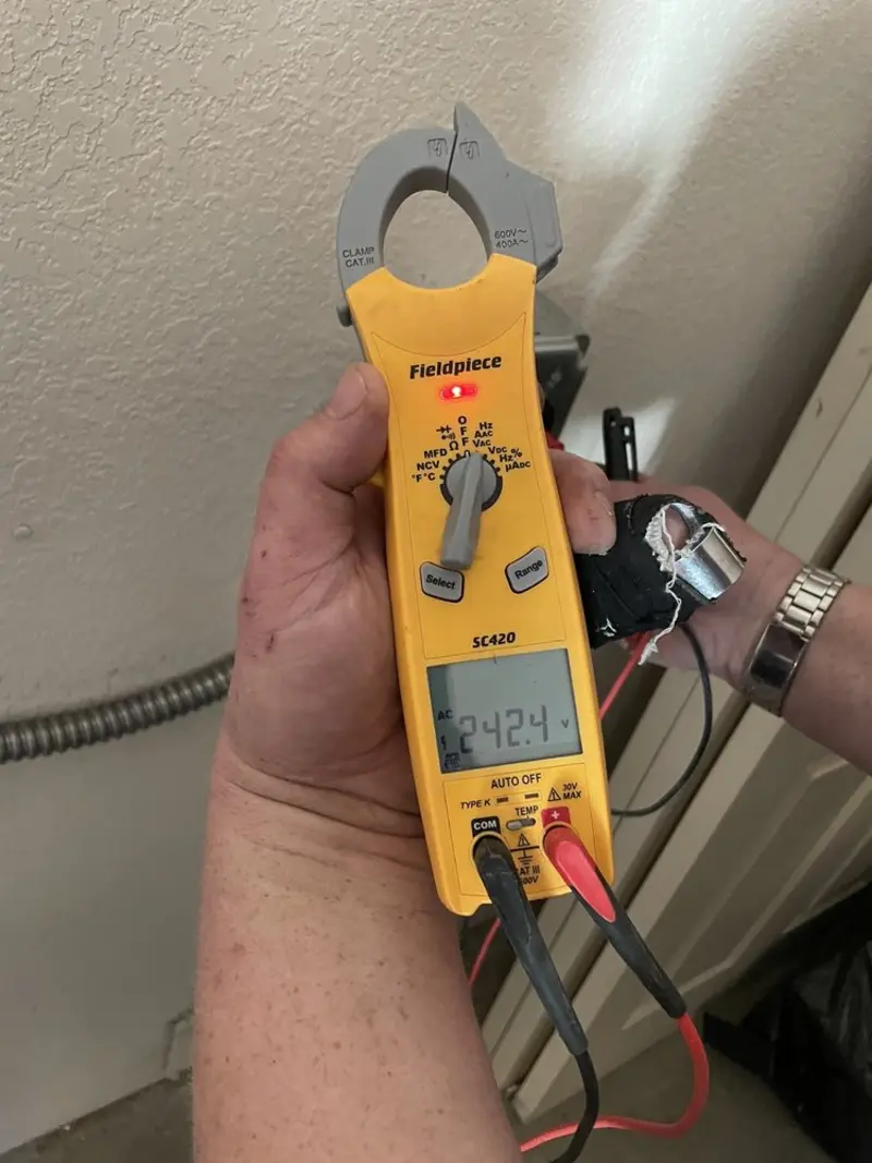 Voltage testing with clamp meter during Ceiling Fan Installation in La Joya